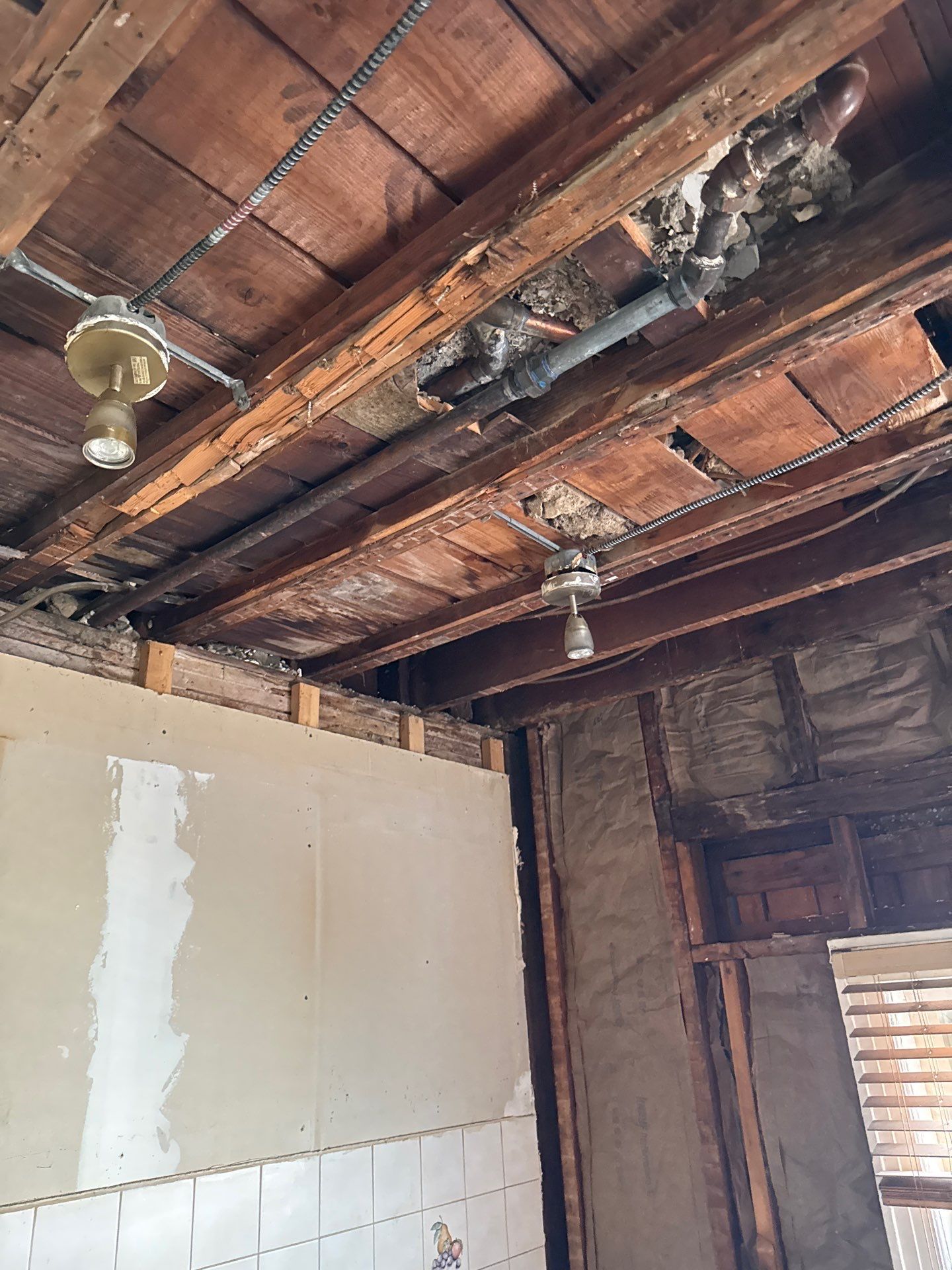 Ceiling opened to expose plumbing
