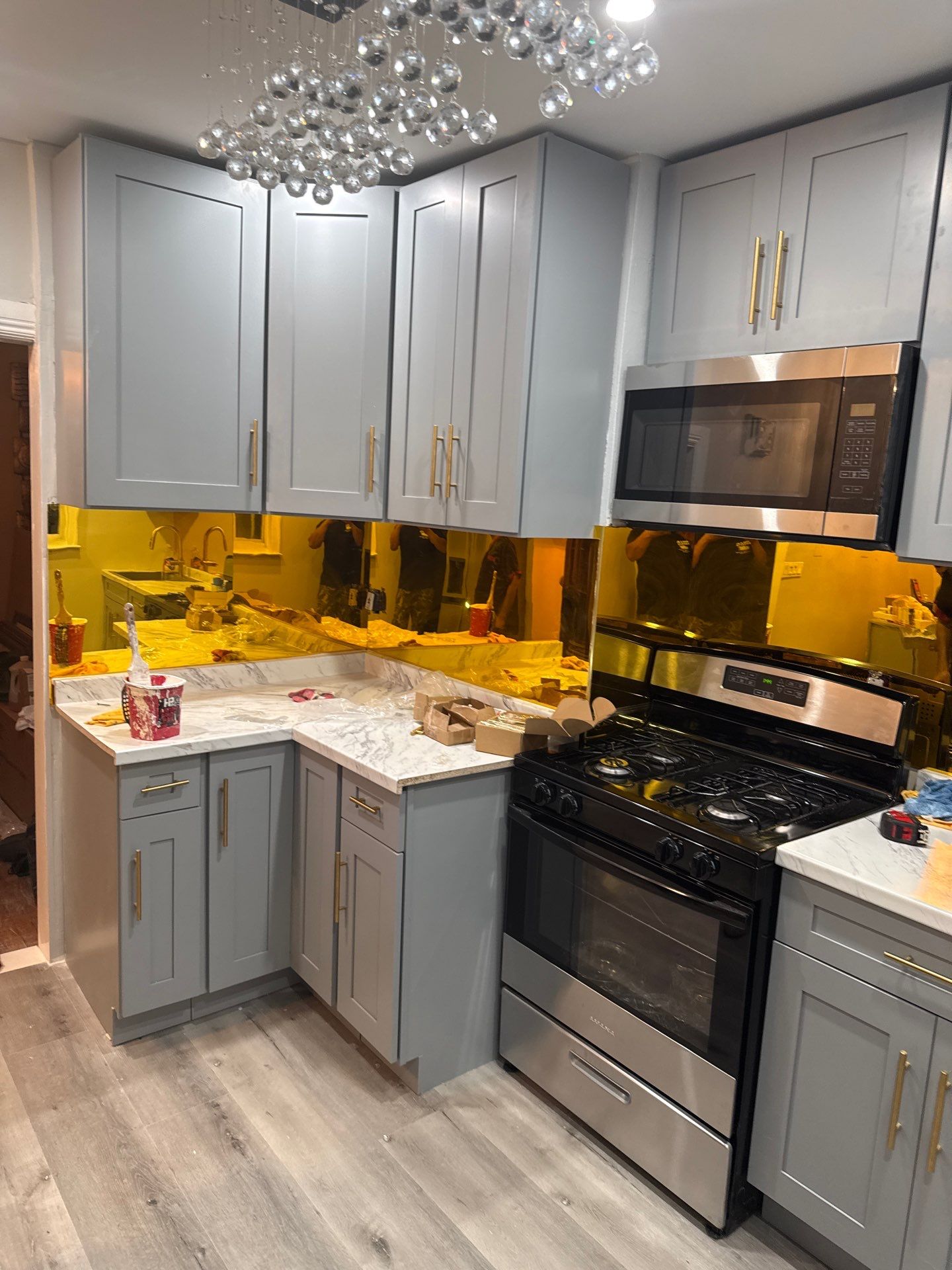 Kitchen cabinets and gold backsplash installed