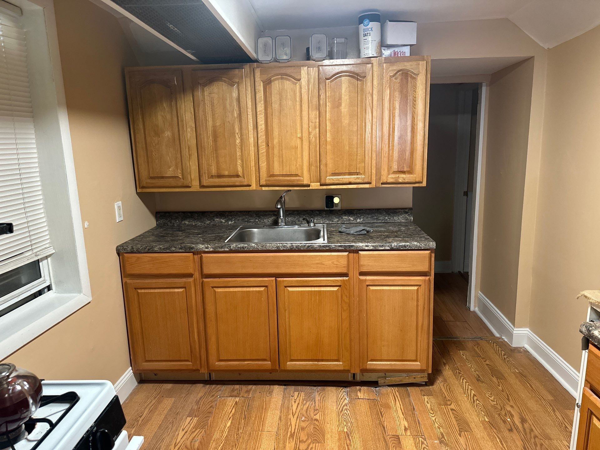 Dated kitchen with oak cabinets before renovation