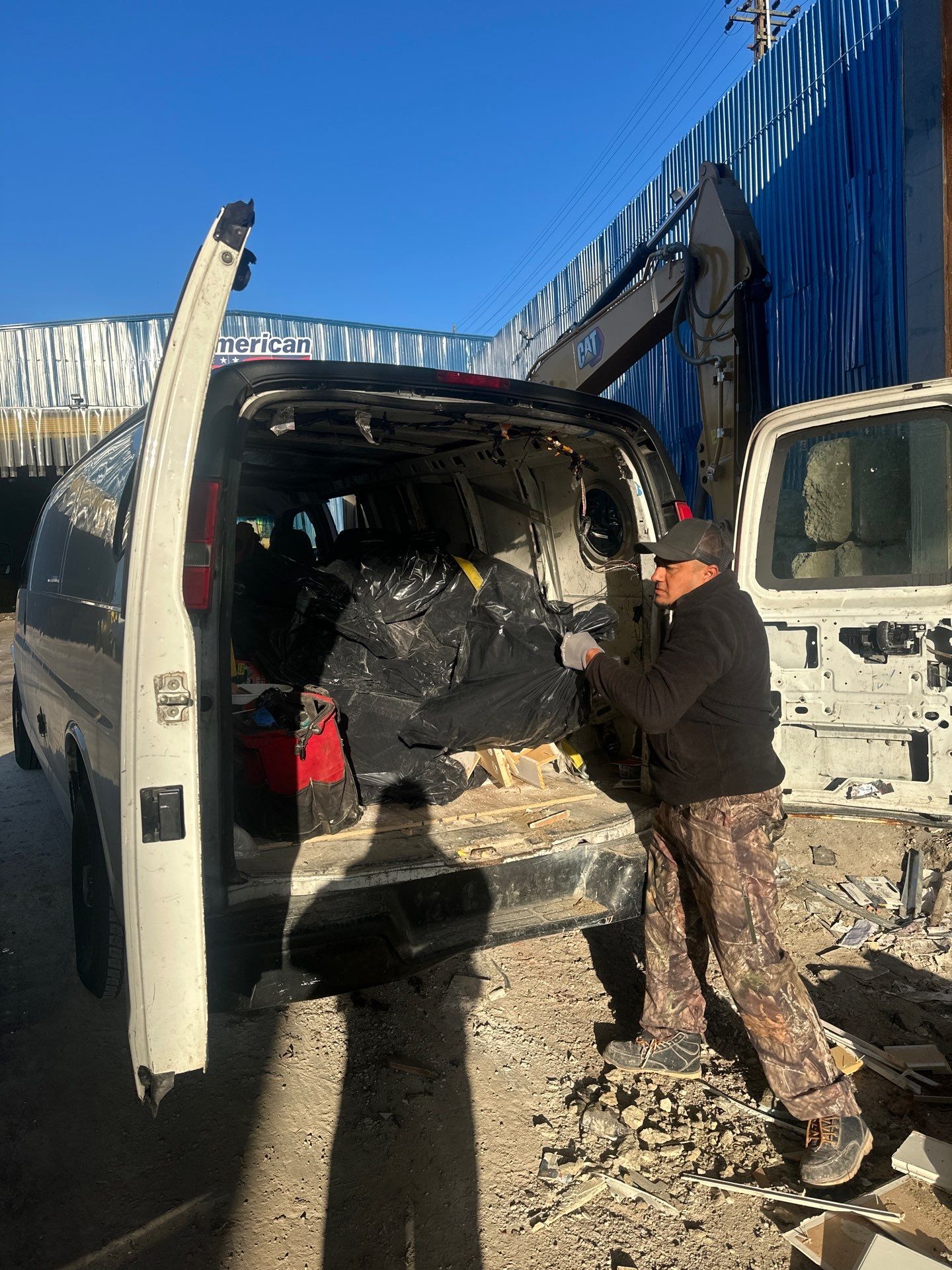 Crew loading debris bags into work van