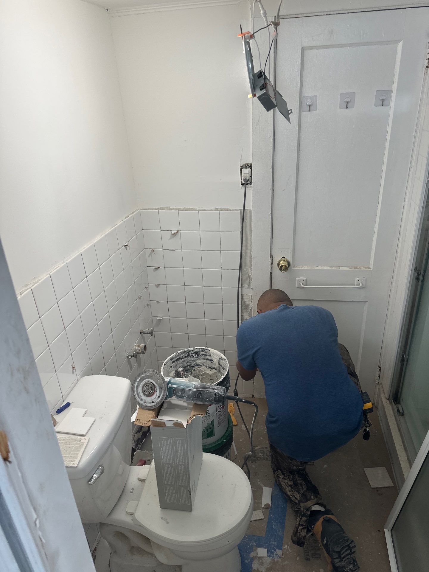 Technician working on bathroom tile